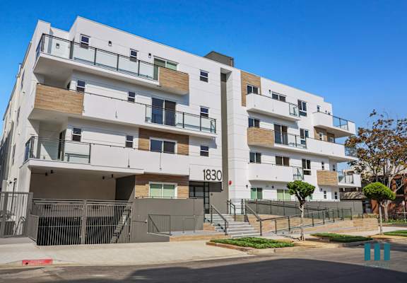 an image of an apartment building with a blue sky in the background