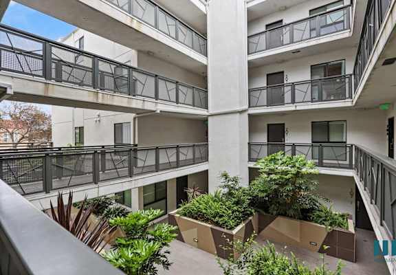 an apartment building with many balconies and plants in therium