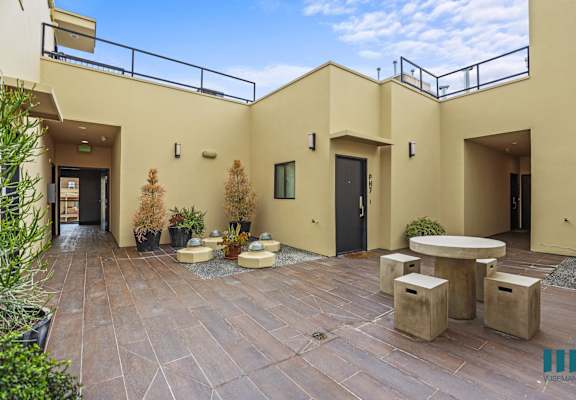 a building with a patio and tables in front of it