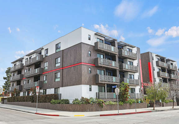 an apartment building on the corner of a street
