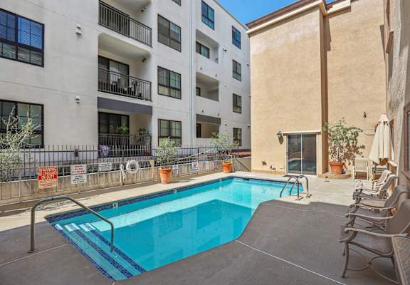 our apartments have a swimming pool and a patio with chairs
