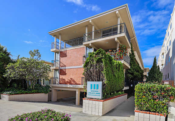 A building with a balcony and a sign that reads "314433 3600".