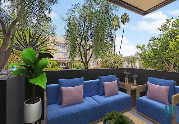 a patio with blue couches and a potted plant