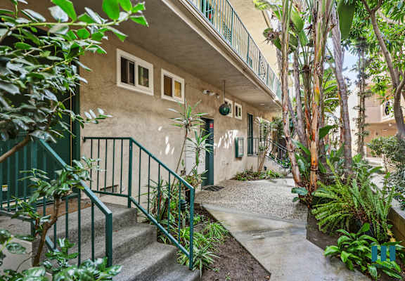 A building with a green railing and steps leading up to it.