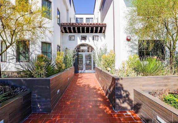 the front entrance to the house has a brick walkway and a glass door