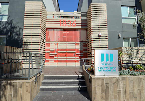 the entrance to a building with a sign in front of it