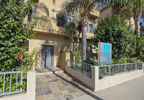 a building with a blue sign in front of it