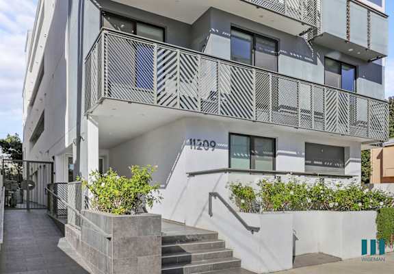 an apartment building with stairs and balconies and a staircase