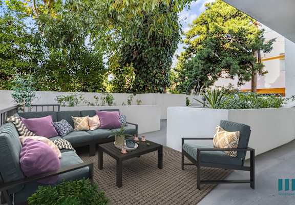 a terrace with couches and chairs and a table