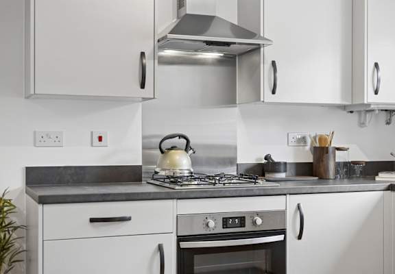 A modern kitchen with a stove and oven.
