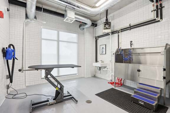 A clean, white room with a table, a vacuum cleaner, and a sink at 2929 on Mayfair, Wauwatosa, WI