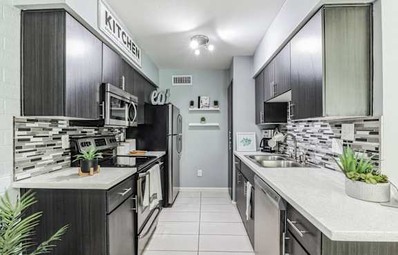 a dining room and kitchen with a table and chairs