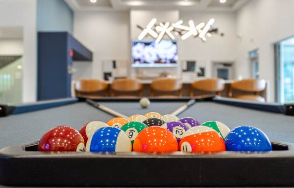 A pool table with a variety of pool balls. at Viridian Apartments LLC Apartments, Kentucky