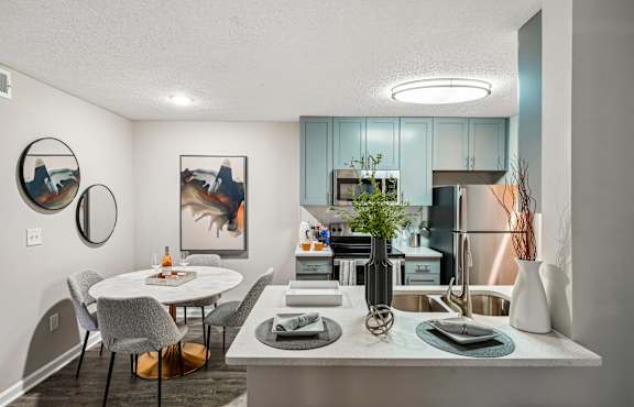 A modern kitchen with a dining table and chairs.