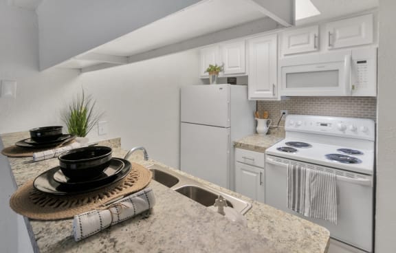 This is a photo of the kitchen in the 477 square foot 1 bedroom apartment at Canyon Creek Apartments in Dallas, TX.
