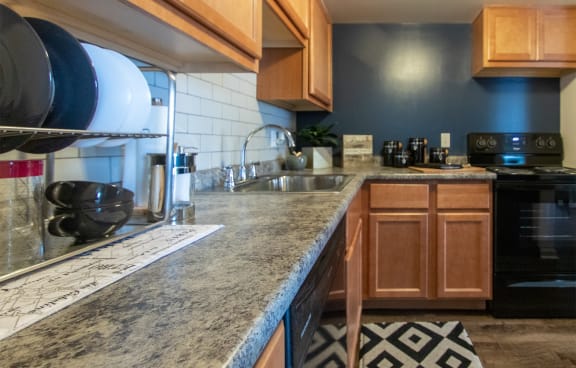 This is a picture of the kitchen in an upgraded 980 square foot, 2 bedroom, 1 bath model apartment at Fairfield Pointe Apartments in Fairfield, Ohio.