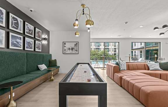 A modern living room with a green sofa and a coffee table.