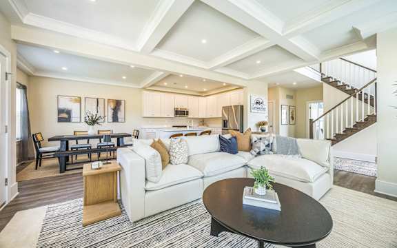 A living room with a black coffee table and a white couch.