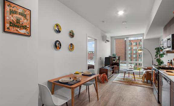 A modern kitchen with a dining table and chairs.