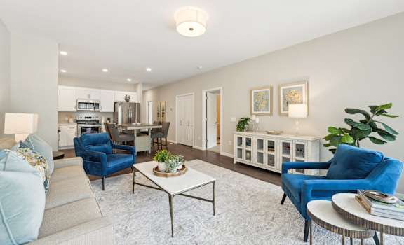 a living room with blue chairs and a table