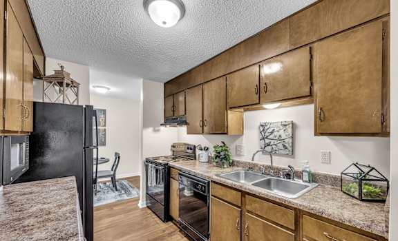 a kitchen with a sink and a refrigerator