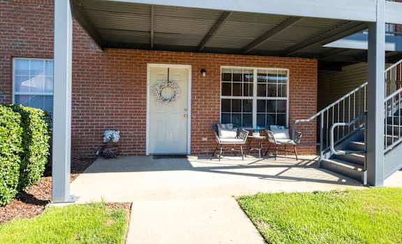 A house with a white door and a wreath on it.