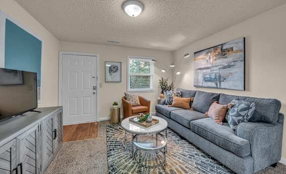 a living room with a couch and a tv