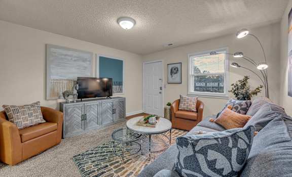 a living room with a couch and a tv