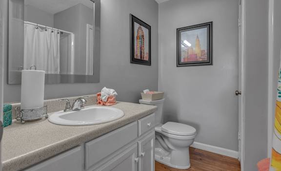 A bathroom with a white toilet and a white sink.