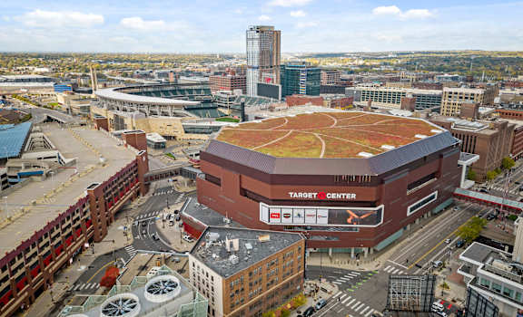 A Target Center sports arena is surrounded by buildings and parking garages.