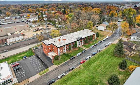 A parking lot with cars and a building in the background.