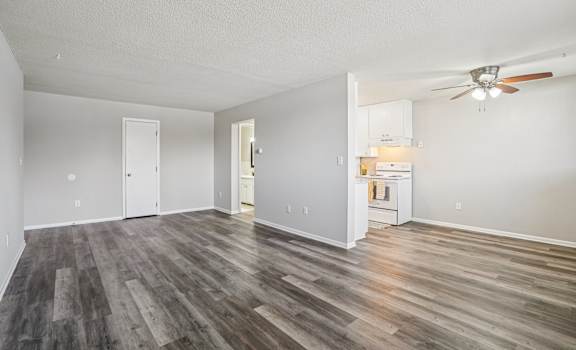 A room with a wooden floor and a ceiling fan.