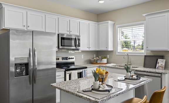 a kitchen with stainless steel appliances and granite counter tops