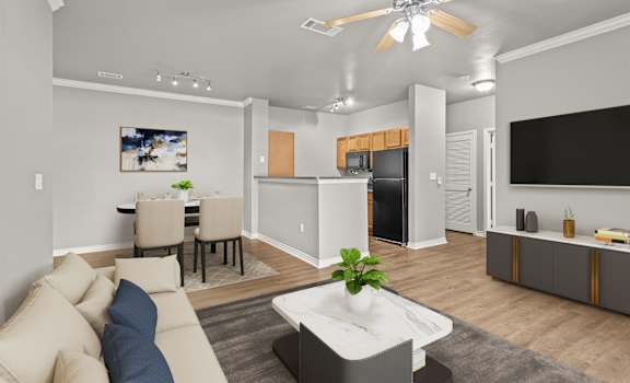 A modern living room with a beige sofa and a white coffee table.