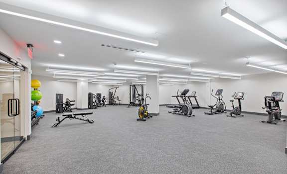 A gym with a variety of exercise equipment.