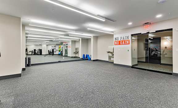 A gym with a sign that says "NO PAIN NO GAIN".