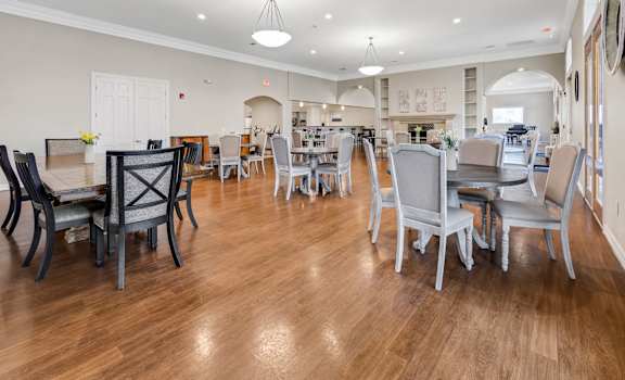 a large dining room with tables and chairs