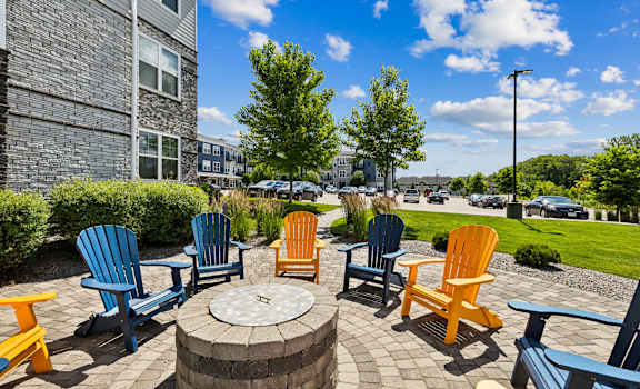 an outside patio with chairs and a fire pit