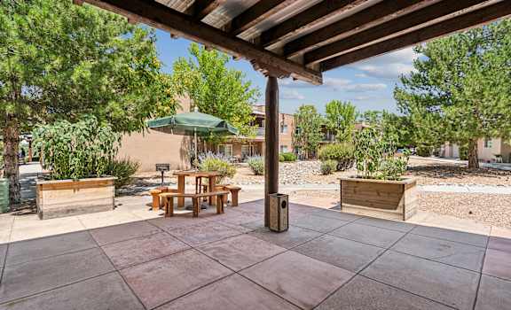 a patio with a table and an umbrella