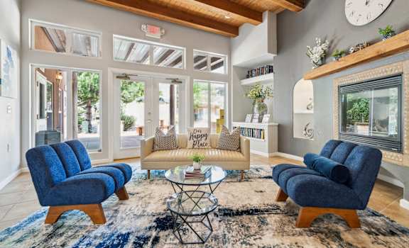 a living room with a couch and chairs and a fireplace