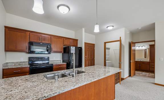 a kitchen with a granite counter top and a sink