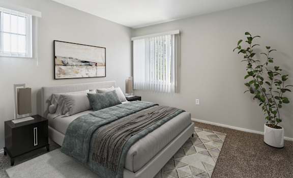 A bedroom with a bed, nightstand, and a plant.