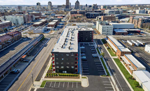 A cityscape with a large building in the foreground and a skyline in the background.