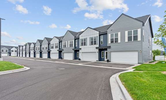 A row of houses with a clear blue sky above them.