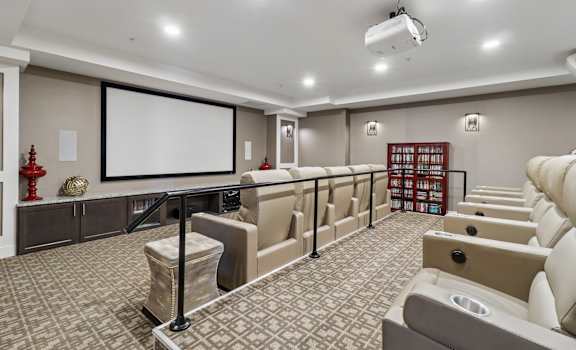 A home theater with a large screen and comfortable seating.