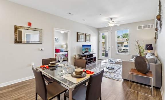 A dining room with a glass table and chairs.