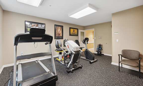 a gym with a treadmill and exercise equipment
