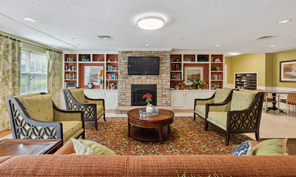 a living room filled with furniture and a fire place