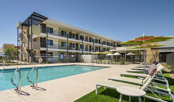 A modern building with a pool in front.
