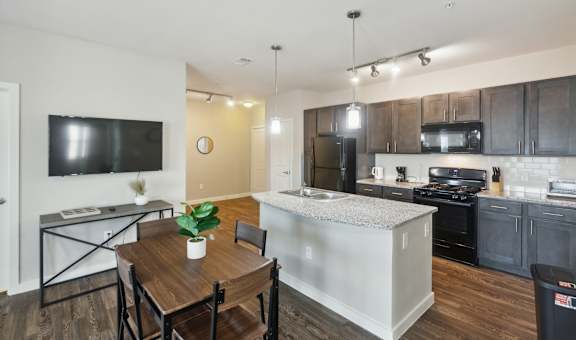 A modern kitchen with a dining table and chairs.